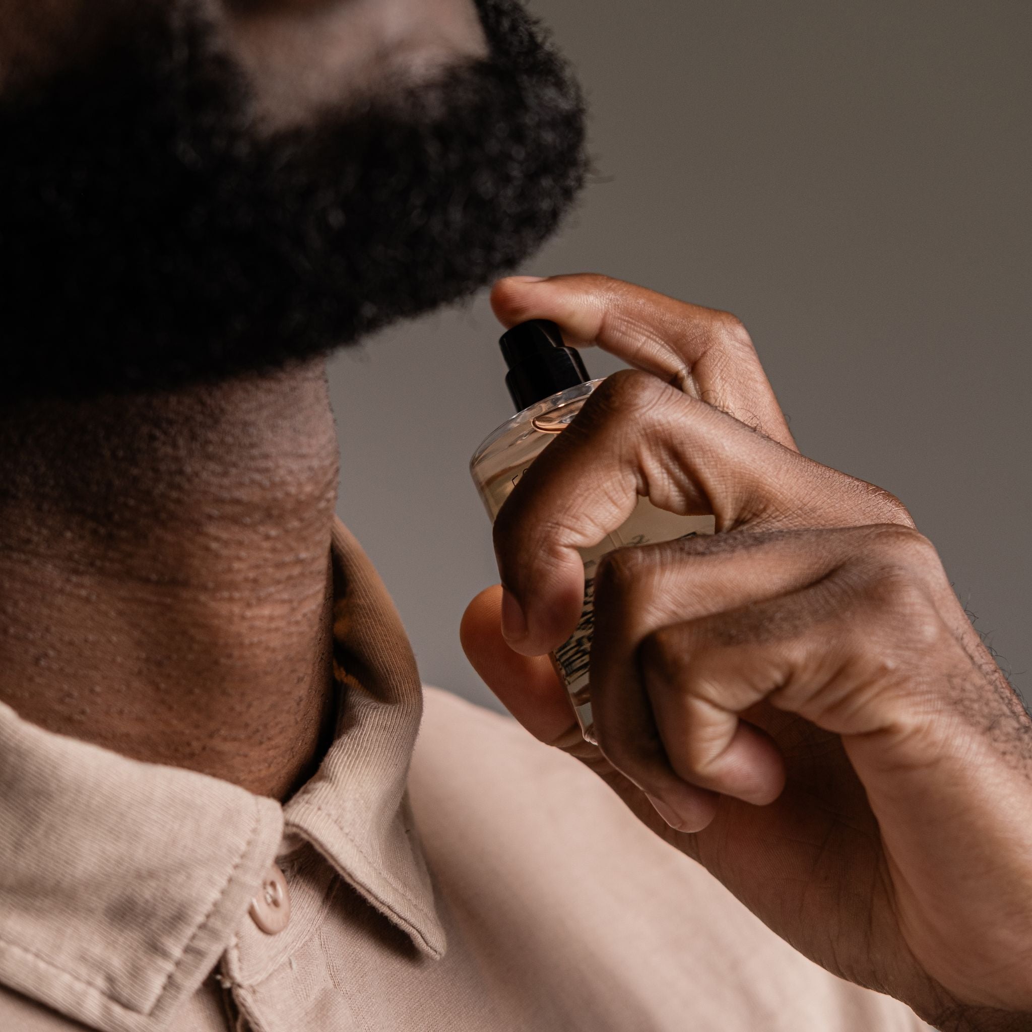  Guy spraying inspired by cologne on neck South Africa