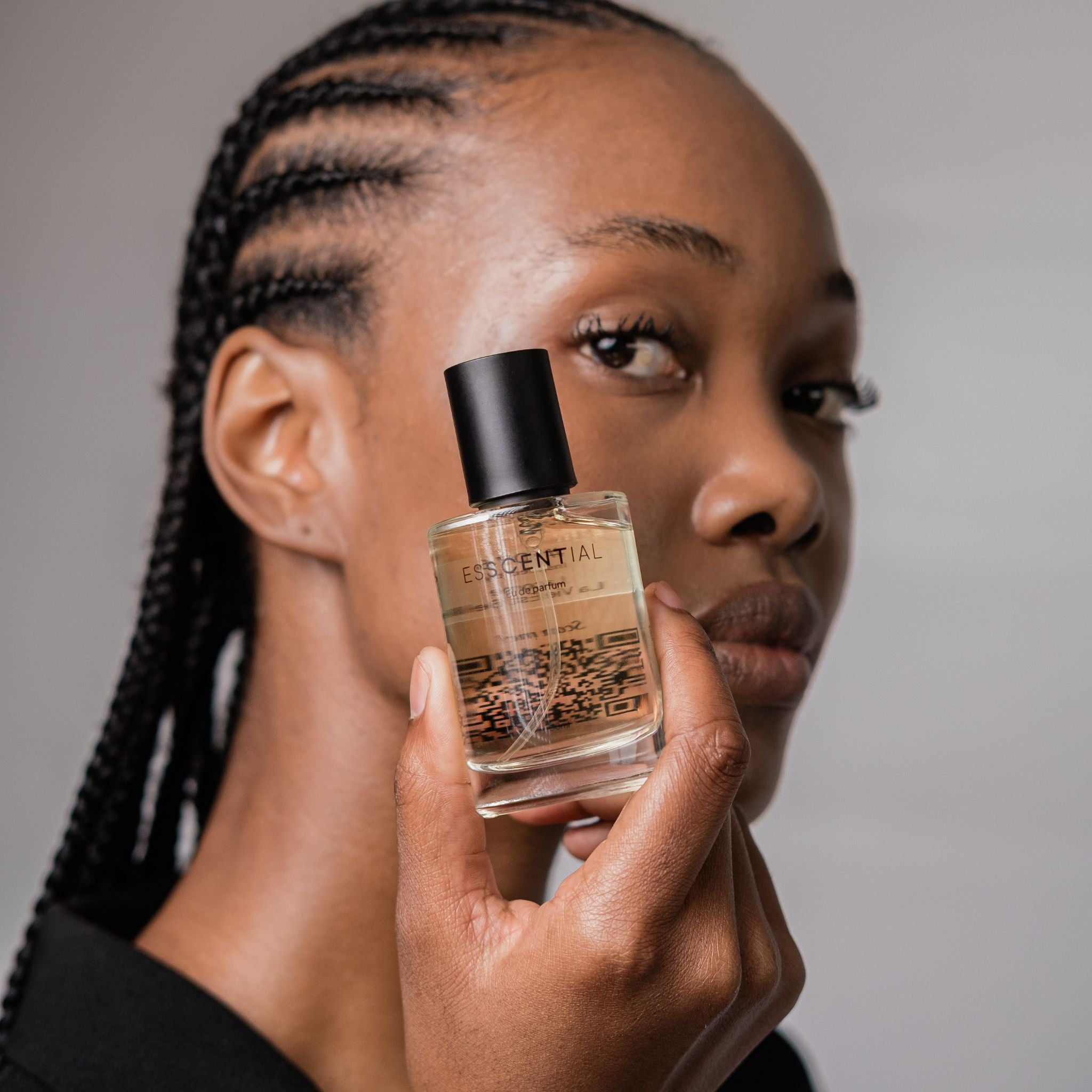  Lady holding perfume bottle to her face South Africa