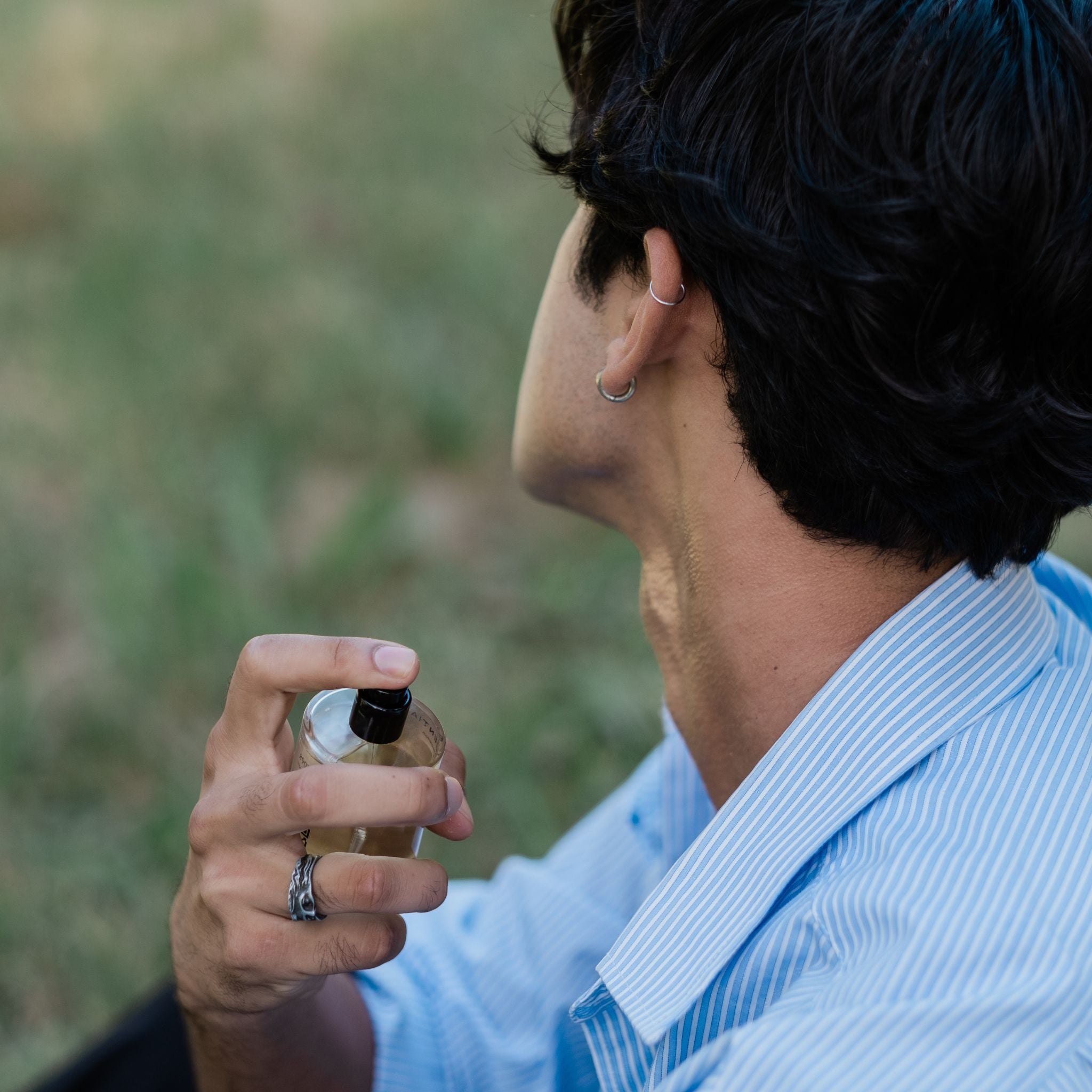  Guy spraying his affordable cologne on his neck South Africa
